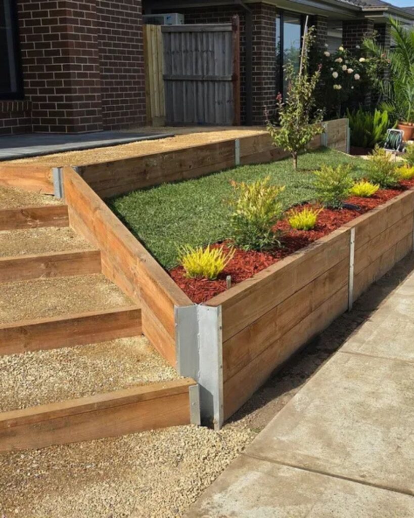 Front yard timber retaining wall with built-in flower bed and fresh landscaping in Bayside